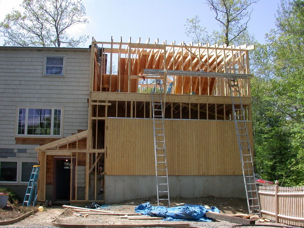 A home under construction to increase square footage - one of the main benefits of home additions.